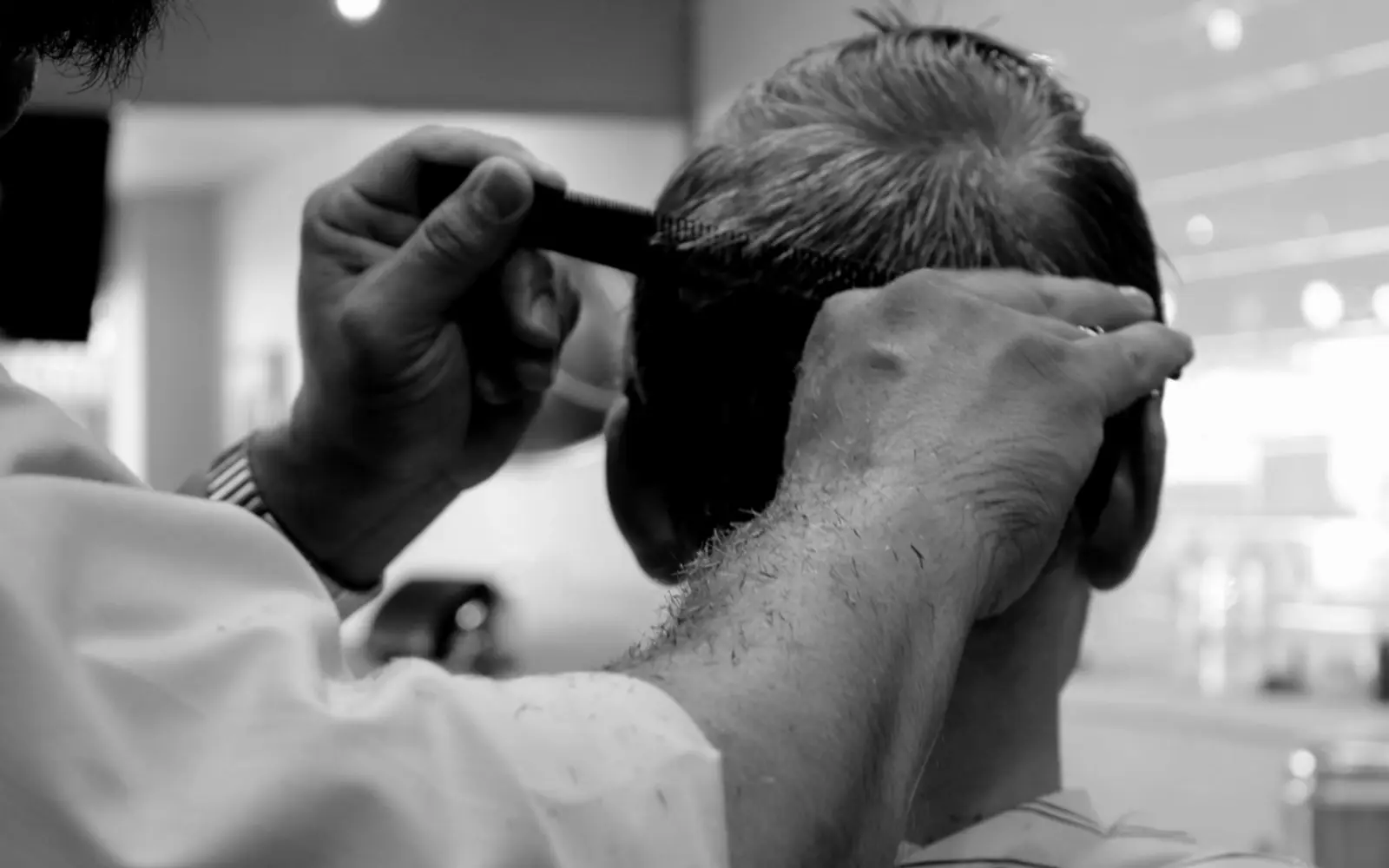 A barber trimming a client's hair